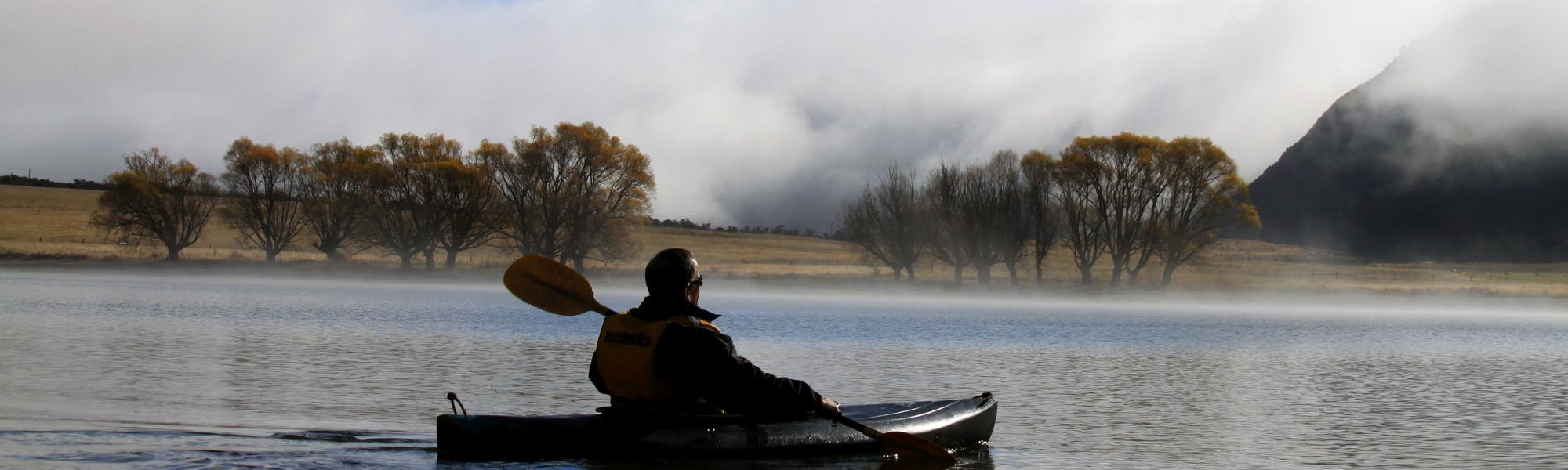 Kayak tranquil mountain lakes