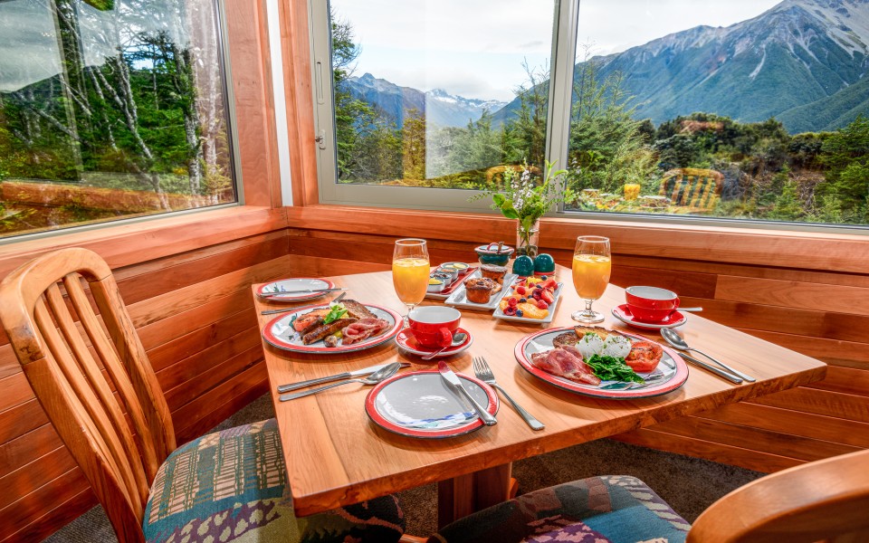 Breakfast table with mountain views from Mt Rolleston Restaurant at Wilderness Lodge Arthur’s Pass.