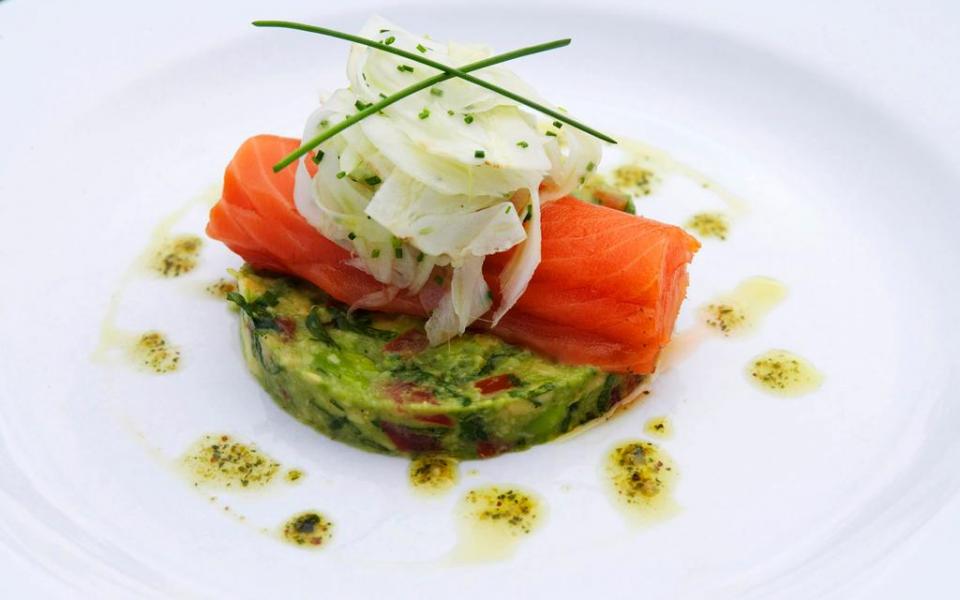 Enjoy delicious West Coast smoked salmon with avocado and shaved fennel when you dine in New Zealand.